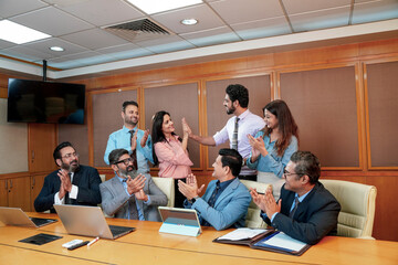 Indian businesspeople group celebrate after dealing feel happy and signing contract or agreement at...