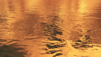 Glossy golden water surface with liquid wavy ripples. Abstract luxury natural background in warm...