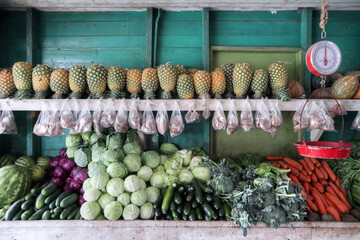 A shelf of tropical fruit and vegetable                    