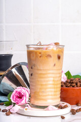 Iced Rose flower latte coffee drink, with pink rose petals taste almond milk, espresso, crushed ice
