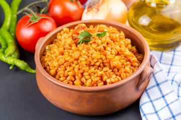 Traditional turkish bulgur pilaf with tomato sause in plate (Turkish name; meyhane pilavi)