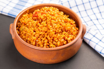 Traditional turkish bulgur pilaf with tomato sause in plate (Turkish name; meyhane pilavi)