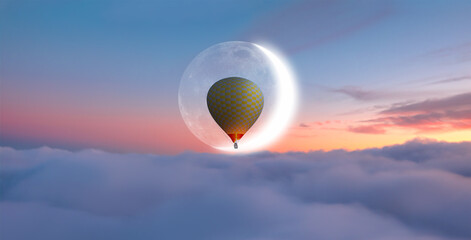 Night sky concept - Hot air balloon over the sunset clouds with crescent moon
