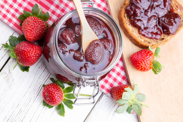 Bowl of strawberry jam isolated on white background from top view