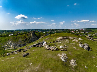 aerial view of Scene of a Shepherd with Sheep and Dog on top of rocky hill in corjeuti, moldova