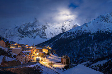 Ecrins National Park with the illuminated village of Le Chazelet and La Meije peak at night. Hautes-Alpes, French Alps, France - obrazy, fototapety, plakaty