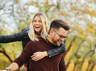woman couple man happy happiness  love young lifestyle together romantic boyfriend girlfriend laughing hug piggyback