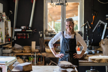 Portrait of confident craftswoman in her workshop
