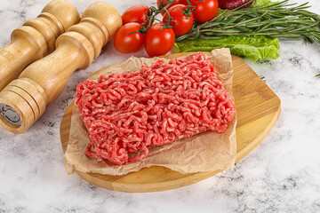 Raw minced beef meat on cutting board