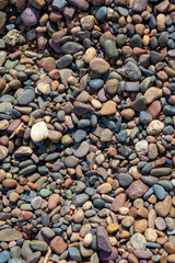 Crushed stone on the seashore. Selective focus on object. The stones were laid on the ground in the garden as a background. Background blur. Pebble stones background.