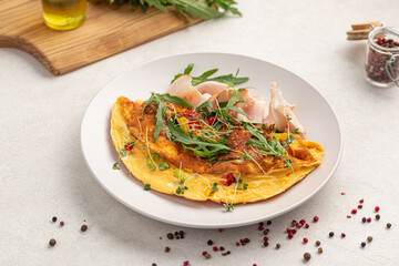 Portion ofgourmet omelette breakfast with smoked chicken