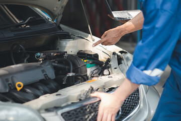 Two professional car mechanics are helping to inspect a customer's car being brought in for repair, all types of auto specialists, expert car repairs and certified auto repair centers.