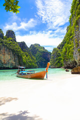 Fototapeta na wymiar The Thai traditional wooden longtail boat and beautiful beach in Phuket province, Thailand.