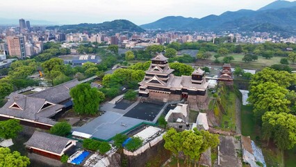 Japanese traditional samurai castle in Kumamoto, historic Edo architecture in Japan, aerial view of Kumamoto castle, famous tourist attraction in Japan. 