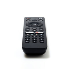 Perspective view of television and audio remote control on white