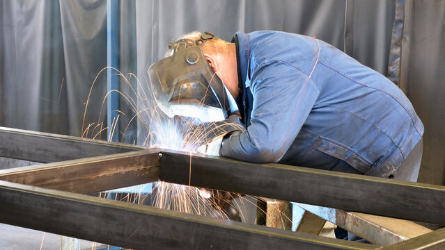 welder at work in a steel construction company - working and protective clothing