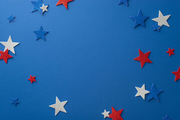 Capture the essence of Independence Day festivities with this top view: glittering stars, showcased on a blue backdrop with an open frame for text or advertising