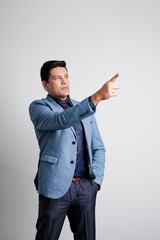 Young indian businessman Giving expression at office.