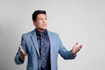 Young indian businessman Giving expression at office.