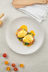 Portion of gourmet eggs benedict with hollandaise sauce
