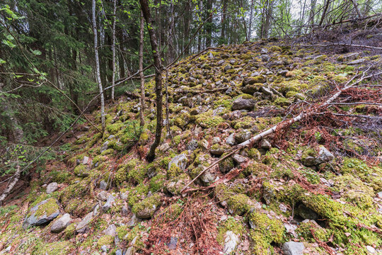 Moss-grown stone pile by the Olterud River in Toten, Norway.