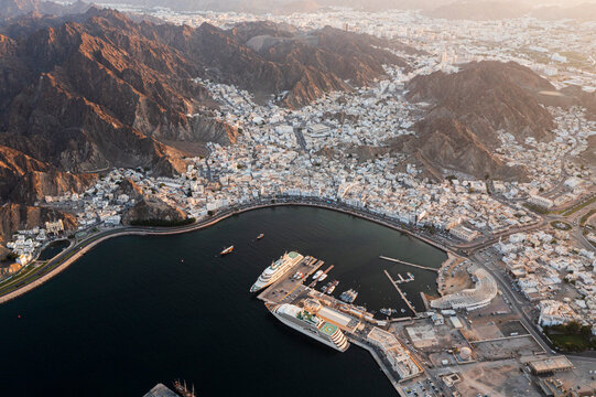 A picture of Muttrah from the sky showing the beauty of the sea, the markets, and the proximity of the royal yachts
