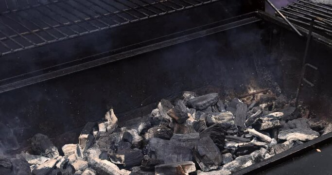 Prepare barbecue for grilling meat over coals and flames on grill