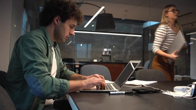 Engineer and programmer sitting in the office and working on the new startup project. 
