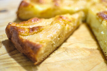 Freshly made Apple Cake sliced in wooden background.