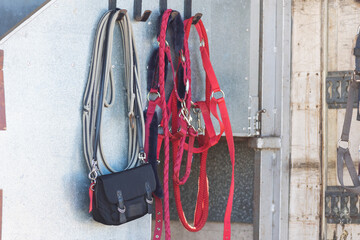 Equipment for saddling horses hanging at the wall