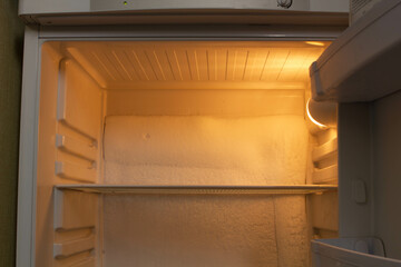 Broken refrigerator with snow inside need repairing. Icing on the back wall of the refrigerator. Freezer repaired in a service workshop. Fridge Inside view. Repair of faulty refrigeration equipment