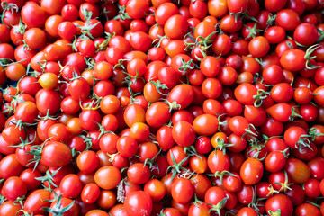 close-up of a lot of tomatoes on the table on the counter of a grocery vegetable market 