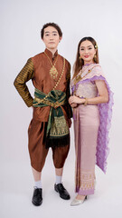 Asian women and Men in traditional thai costume smiling isolated on white background, Thailand traditional culture