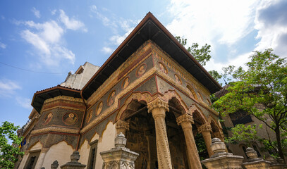 Obraz premium Stavropoleos Monastery landmark in Bucharest, wide angle photo with this iconic church during a sunny summer day. Travel to Bucharest, Romania, 2023.