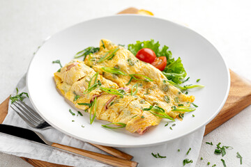 Portion of gourmet omelette breakfast with ham