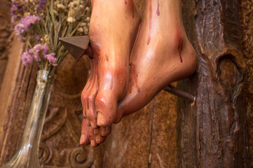 Feet of a crucified Christ pierced by a nail