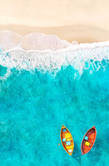 Fototapeta premium Aerial View of Sandy Tropical Beach and Ocean with Yellow and Red Boats Floating on Turquoise Water
