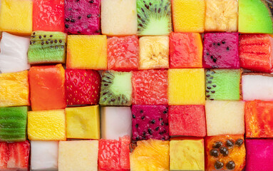 Fruit puzzle. Colorful food background or pattern arranged of different fruit cubes. Dietary concept.