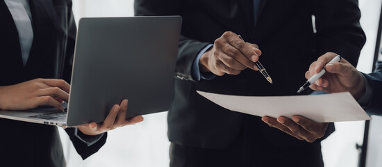 Managers are using report to analyze sales cost reports and explain summary reports to employees calculate and record summary information data in the office.