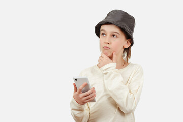 Cute boy using a smart phone over white background. Smart kid holding a mobile phone.