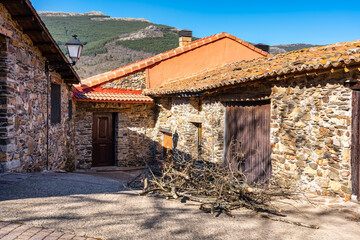 Rural houses of stone and firewood at the door to spend the winter in the mountains of Madrid, Puebla de la Sierra.