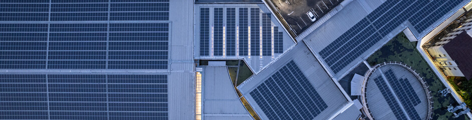 Solar roof, Solar on the roof, top view worker installing a solar cell on the factory roof, panels on tin roof seen from aerial view, panesl power