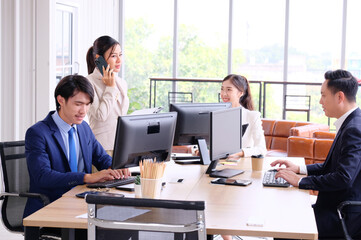 Businessmen and employees sitting on desks in the office business idea.