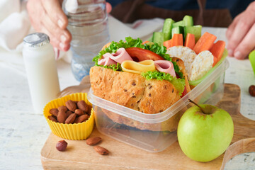 Healthy food for school lunch concept. Care father making school lunch. Sandwich with healthy...