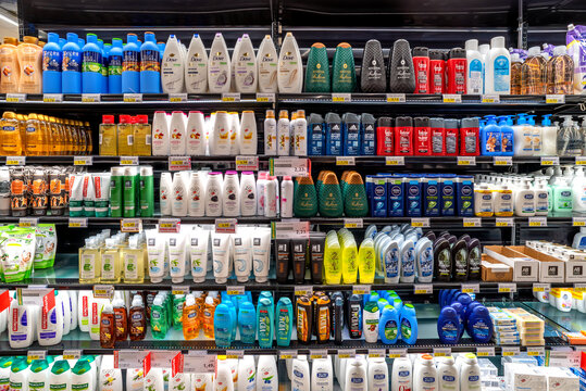 Italy - May 25, 2023: packs of shampoo and shower foam of different brands displayed for sale on Italian supermarket shelf. Cosmetics and body care products in supermarket