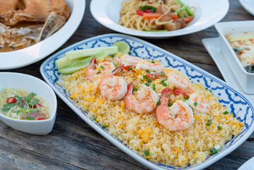 Fried rice with shrimp (Thai style) on wooden table that serve with main menu