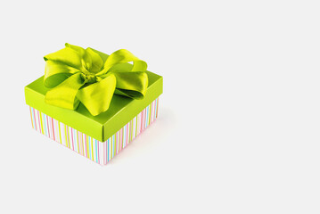 Multicolored gift box with a bow on a white background.