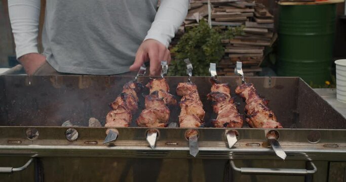 Close-up fries meat skewers. Barbecue on skewers. Barbecue grill. Leisure, food, people, holidays