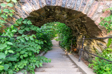 Narrow staircase going under an archway in Slottsskogen park in Gothenburg, Sweden