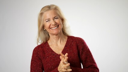 Excited shocked surprised elderly blonde woman lady 50s years old wear sweater shirt ask says wow omg no way say yes celebrating put hands on face isolated solid white background studio portrait